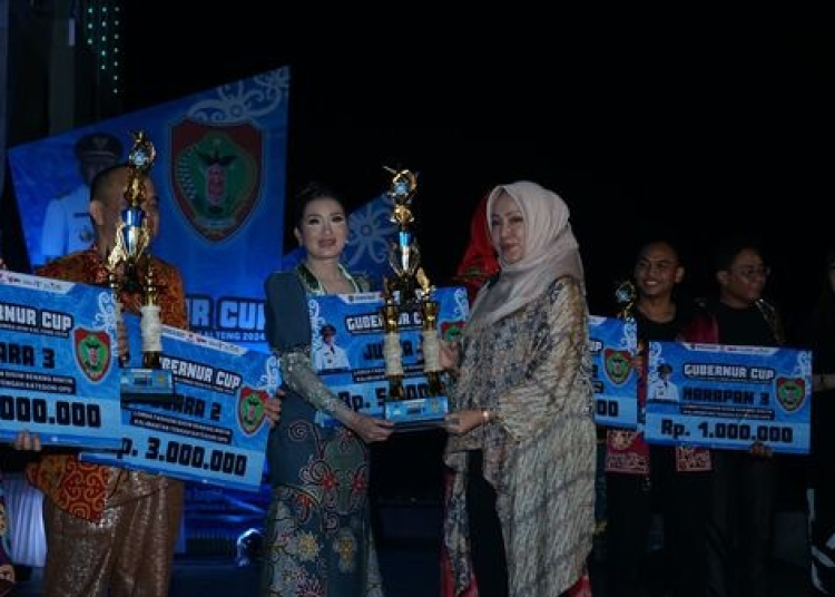 Kepala Dinas Kebudayaan dan Pariwisata Prov. Kalteng Adiah Chandra Sari menyerahkan piala bagi peringkat pertama Lomba Fashion Show Benang Bintik Kategori OPD yaitu Esterina dari DP3APPKB Prov. Kalteng beserta pemenang dari kategori umum lainnya.(Photo/tk)